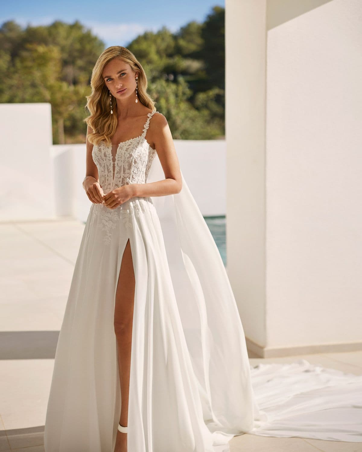Salina by Adriana Alier, a bridal gown against white architecture
